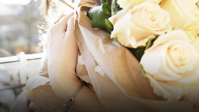 Bouquet of flowers on model wearing a Trollbeads bracelet